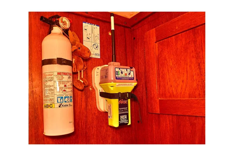 Slide: The Image of Fire extinguisher and emergency beacon on 1981 Valiant Cutter wooden interior. - 78