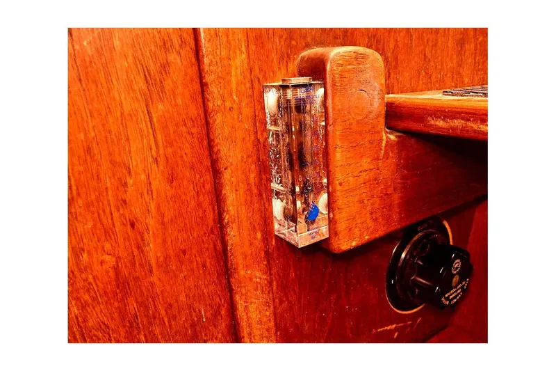 Slide: The Image of Wooden interior detail of a 1981 Valiant Cutter boat with a mounted level gauge. - 86
