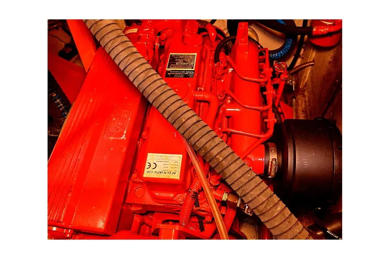 Slide: The Image of 1981 Valiant Cutter engine, vibrant red components, detailed mechanical parts. - 87