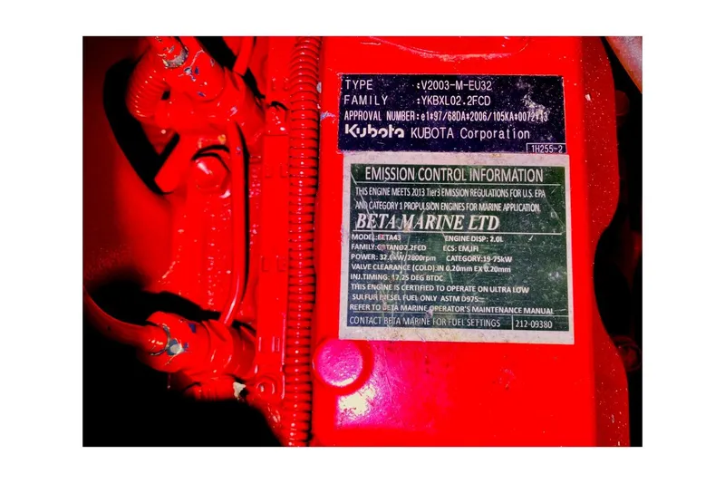 Slide: The Image of Red engine with emission control information label from Kubota and Beta Marine. - 88