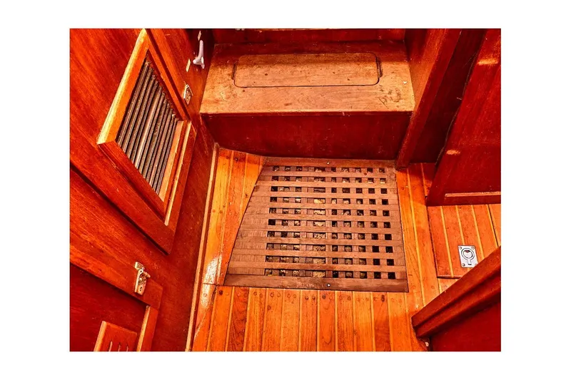 Slide: The Image of Interior of 1981 Valiant Cutter boat with wooden flooring and vented panel. - 92
