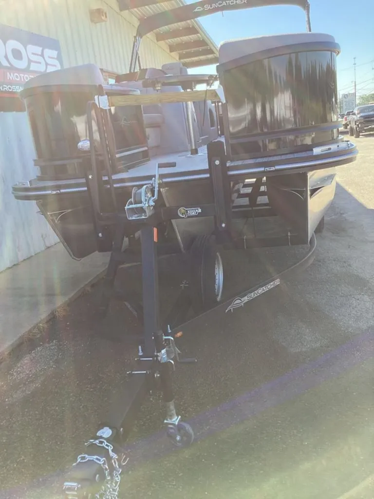 Slide: The Image of 2026 SunCatcher Fusion 324SS boat on trailer in sunlight. - 14
