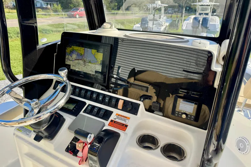 Slide: The Image of 2018 Sea Hunt BX 25 FS boat dashboard with navigation system and steering wheel. - 15
