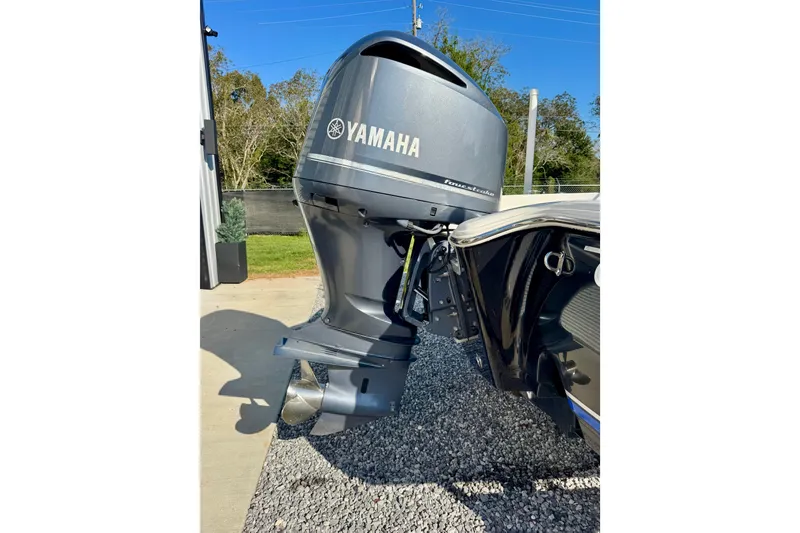 Slide: The Image of 2018 Sea Hunt BX 25 FS with Yamaha outboard motor, parked on gravel. - 3