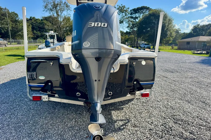 Slide: The Image of 2018 Sea Hunt BX 25 FS boat with Yamaha 300 engine, parked on gravel. - 6