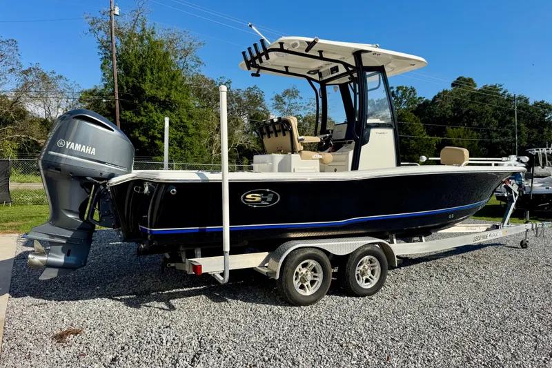 Slide: The Image of 2018 Sea Hunt BX 25 FS boat on trailer with Yamaha engine, parked outdoors. - 7