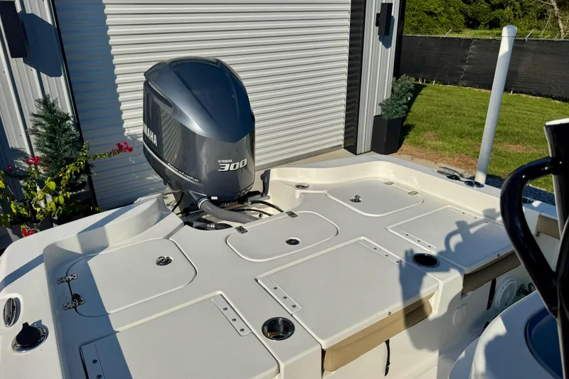 Slide: The Image of 2018 Sea Hunt BX 25 FS boat with Yamaha 300 engine, parked outdoors. - 9