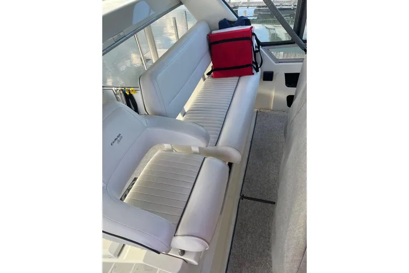 Slide: The Image of 1993 Carver 350 Aft Cabin Motor Yacht interior with white seating and red cooler. - 10