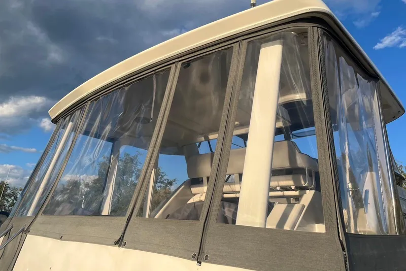 Slide: The Image of 1993 Carver 350 Aft Cabin Motor Yacht with clear enclosure under a blue sky. - 11