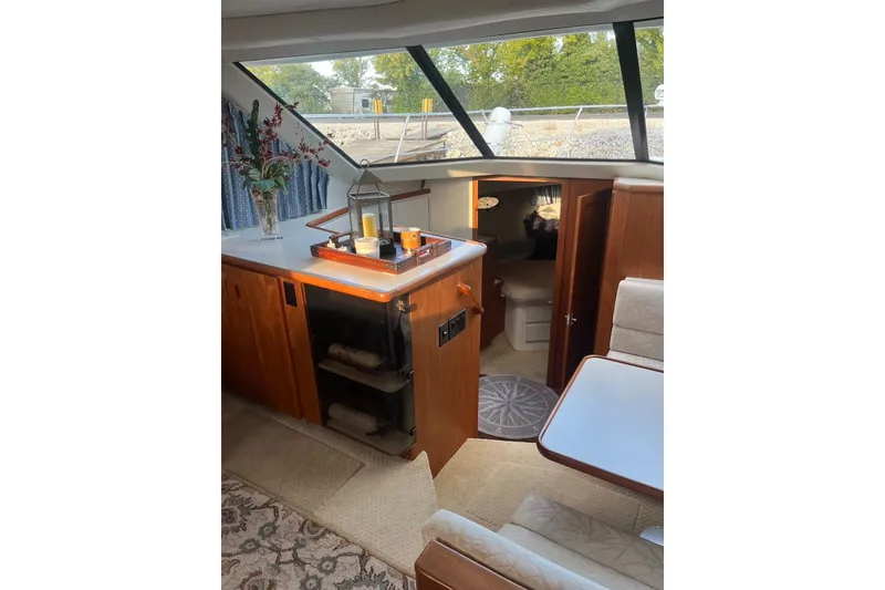 Slide: The Image of Interior of 1993 Carver 350 Aft Cabin Motor Yacht with elegant wood finish and seating area. - 19