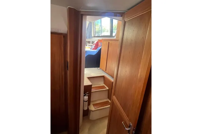 Slide: The Image of Interior view of 1993 Carver 350 Aft Cabin Motor Yacht with wooden doors and steps. - 24