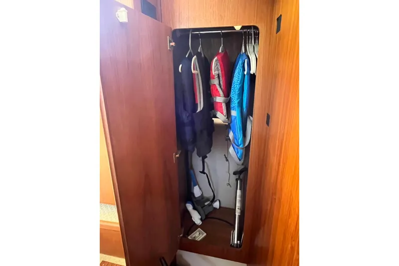 Slide: The Image of Closet in 1993 Carver 350 Aft Cabin Motor Yacht with life jackets and hangers. - 27