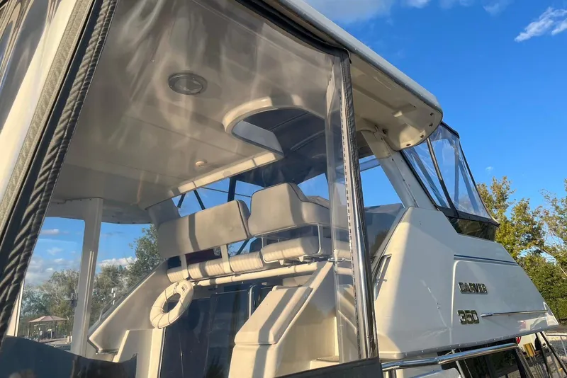 Slide: The Image of 1993 Carver 350 Aft Cabin Motor Yacht with clear enclosure, under a blue sky. - 12