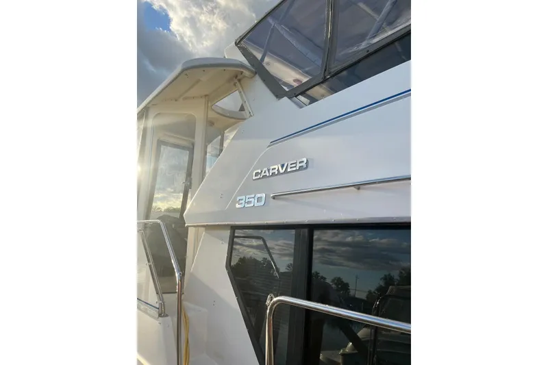 Slide: The Image of 1993 Carver 350 Aft Cabin Motor Yacht, exterior view with sunlight reflection. - 13