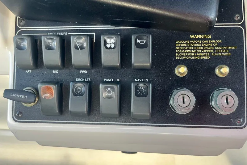 Slide: The Image of Control panel of a 1993 Carver 350 Aft Cabin Motor Yacht with switches and warning label. - 15