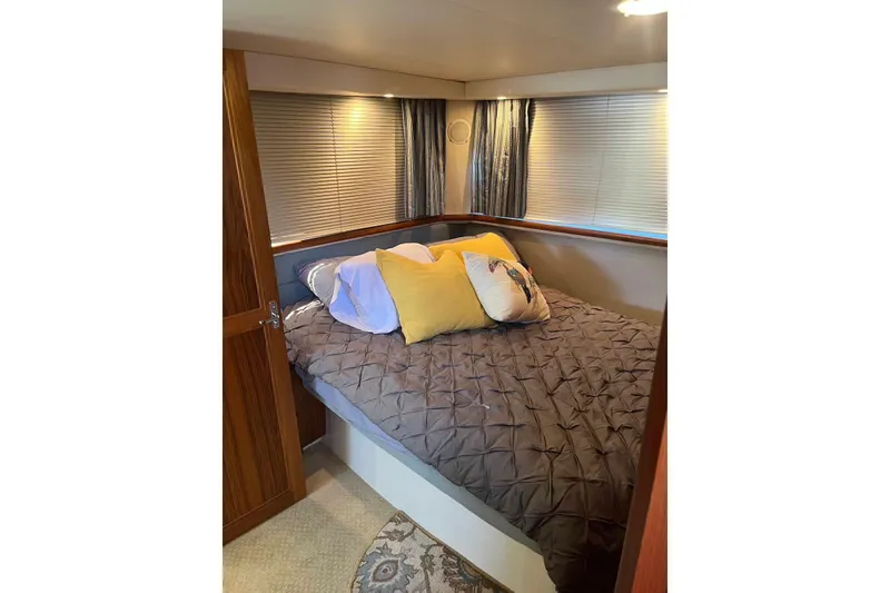 Slide: The Image of Cozy bedroom in 1993 Carver 350 Aft Cabin Motor Yacht with plush bedding. - 21