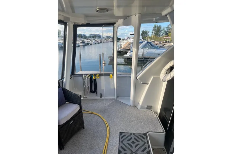 Slide: The Image of 1993 Carver 350 Aft Cabin Motor Yacht interior with marina view. - 3