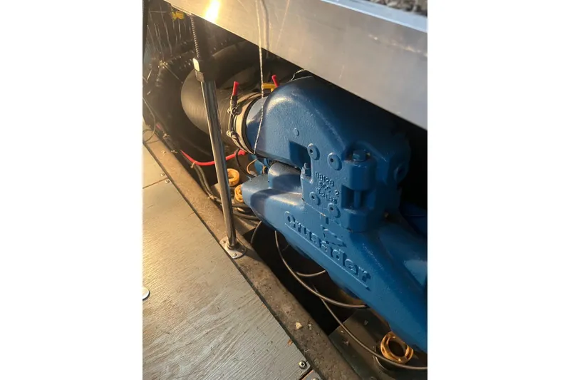 Slide: The Image of Engine compartment of 1993 Carver 350 Aft Cabin Motor Yacht, featuring blue Crusader engine. - 36