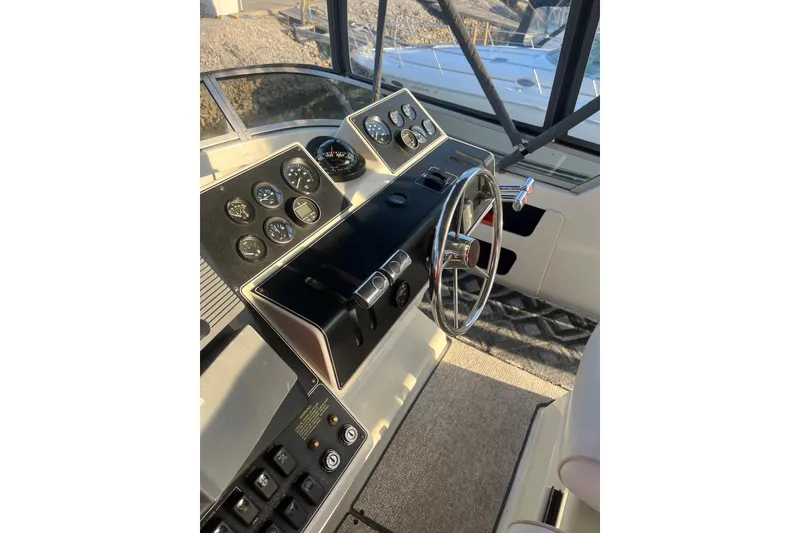 Slide: The Image of 1993 Carver 350 Aft Cabin Motor Yacht helm with gauges and steering wheel. - 5