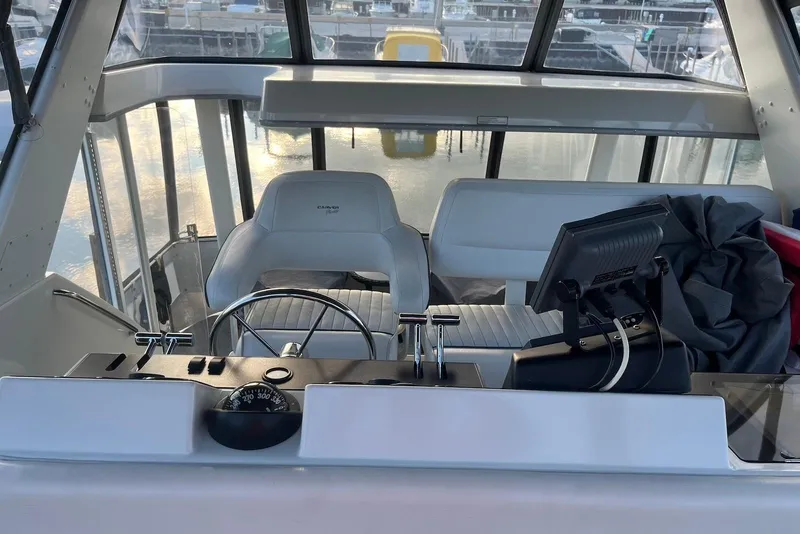 Slide: The Image of 1993 Carver 350 Aft Cabin Motor Yacht helm with steering wheel and navigation equipment. - 7