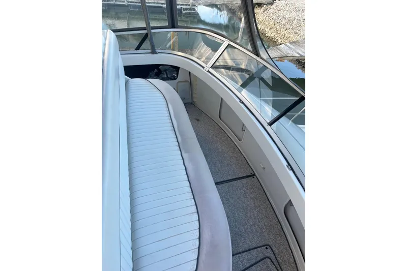 Slide: The Image of 1993 Carver 350 Aft Cabin Motor Yacht interior with cushioned seating and windows. - 9