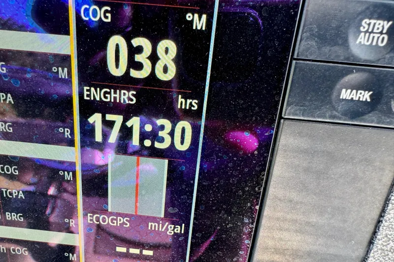 Slide: The Image of Close-up of a 2017 Crevalle 26 Bay boat's navigation display showing engine hours and course. - 14