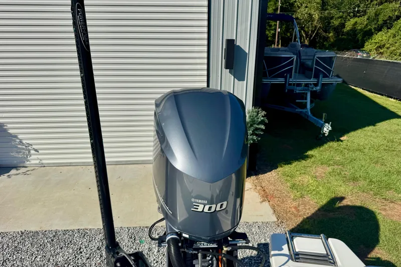 Slide: The Image of 2017 Crevalle 26 Bay with Yamaha 300 engine, parked near a metal building. - 15
