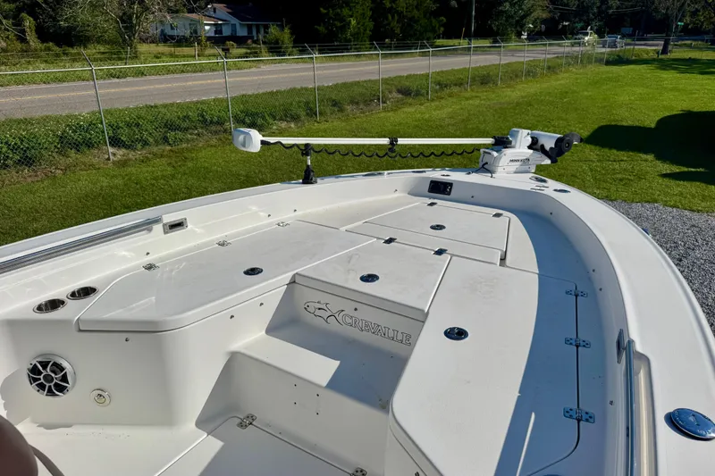 Slide: The Image of 2017 Crevalle 26 Bay boat deck with storage compartments and trolling motor. - 17