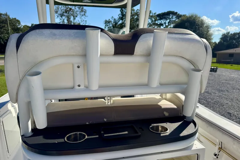 Slide: The Image of 2017 Crevalle 26 Bay boat seat with rod holders and cup holders, outdoors. - 19
