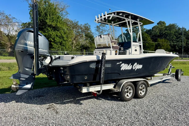 Slide: The Image of 2017 Crevalle 26 Bay boat on trailer with Yamaha engine, parked outdoors. - 3
