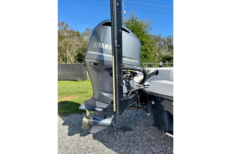 Slide: The Image of 2017 Crevalle 26 Bay boat with Yamaha outboard motor, parked on gravel. - 4