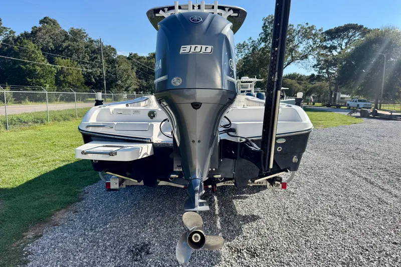 Slide: The Image of 2017 Crevalle 26 Bay boat with Yamaha 300 engine, parked on gravel. - 5