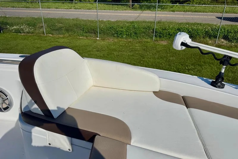 Slide: The Image of 2017 Crevalle 26 Bay boat seat with white and brown upholstery, near a grassy area. - 7