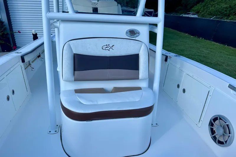 Slide: The Image of 2017 Crevalle 26 Bay boat interior with cushioned seating and storage compartments. - 8