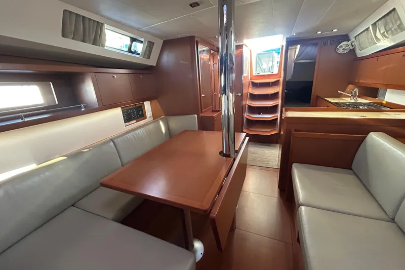 Slide: The Image of Interior of 2014 Beneteau Oceanis 41 sailboat with dining area and kitchen. - 10
