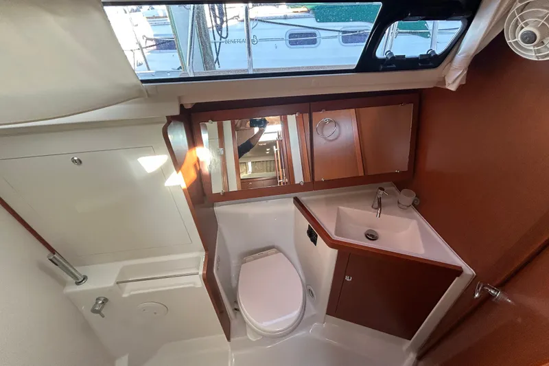 Slide: The Image of Bathroom interior of 2014 Beneteau Oceanis 41 yacht, featuring sink, toilet, and mirror. - 11