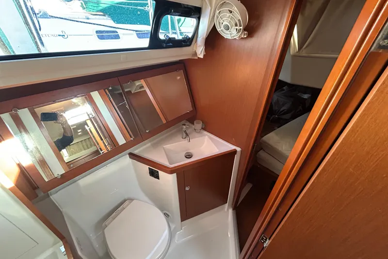 Slide: The Image of 2014 Beneteau Oceanis 41 yacht bathroom with sink, toilet, and mirror. - 12