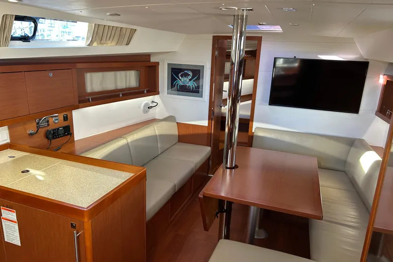 Slide: The Image of Luxurious interior of 2014 Beneteau Oceanis 41 yacht with modern seating and entertainment area. - 16