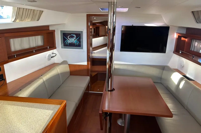 Slide: The Image of Interior of 2014 Beneteau Oceanis 41 yacht with modern seating and wall art. - 17