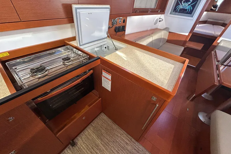 Slide: The Image of Interior of 2014 Beneteau Oceanis 41 yacht kitchen with stove and seating area. - 21