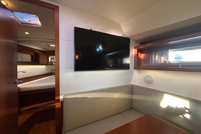 Slide: The Image of Interior of 2014 Beneteau Oceanis 41 yacht with TV and seating area. - 24