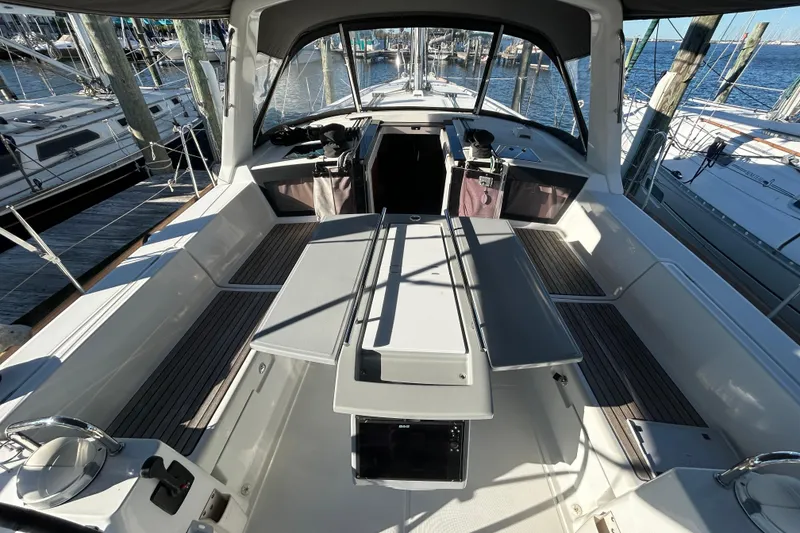 Slide: The Image of 2014 Beneteau Oceanis 41 sailboat cockpit with seating and table, docked at marina. - 27