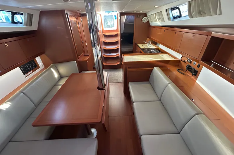 Slide: The Image of Interior of 2014 Beneteau Oceanis 41 yacht with modern wood finish and seating area. - 8