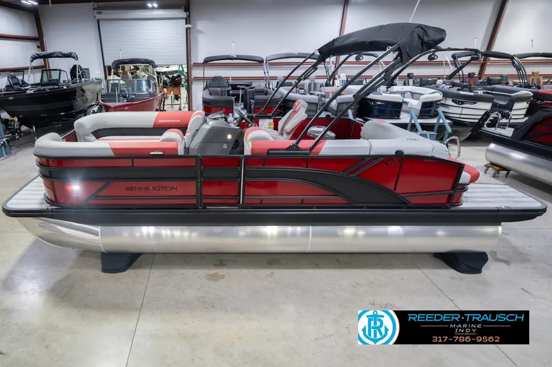 The Image of 2026 Bennington 22 SLJ pontoon boat in showroom, featuring red and gray seating. - 0