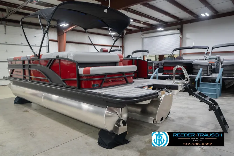 Slide: The Image of 2026 Bennington 22 SLJ pontoon boat in showroom, featuring sleek design and modern amenities. - 10