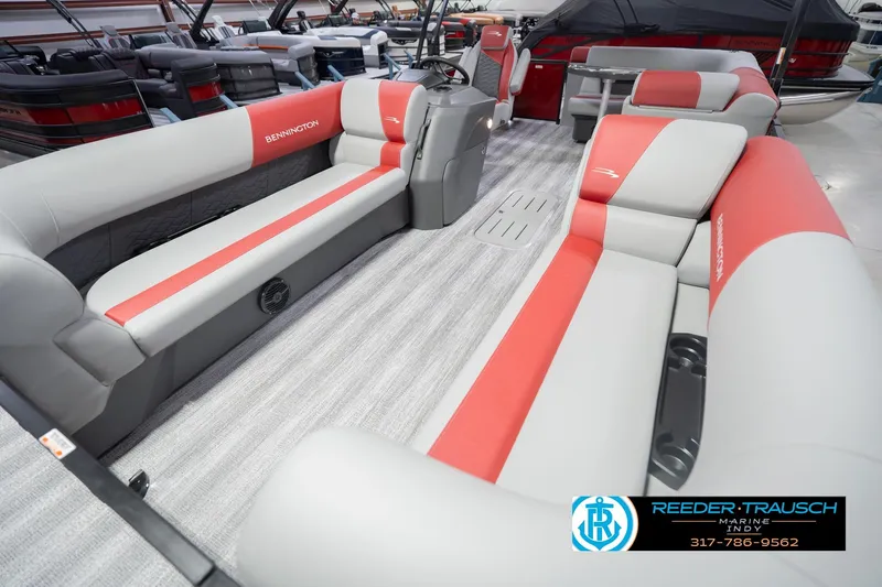 Slide: The Image of 2026 Bennington 22 SLJ pontoon boat interior with red and gray seating, showroom display. - 12