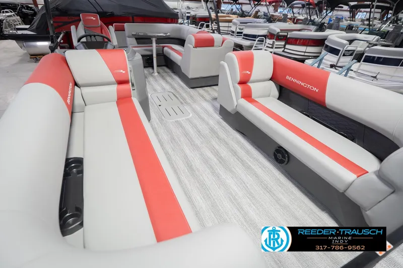 Slide: The Image of 2026 Bennington 22 SLJ pontoon boat interior with red and gray seating, showcased at Reeder-Trausch Marine. - 13