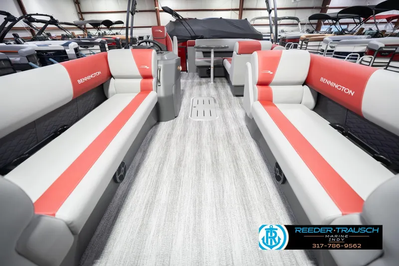Slide: The Image of 2026 Bennington 22 SLJ pontoon boat interior with red and gray seating, showroom display. - 16