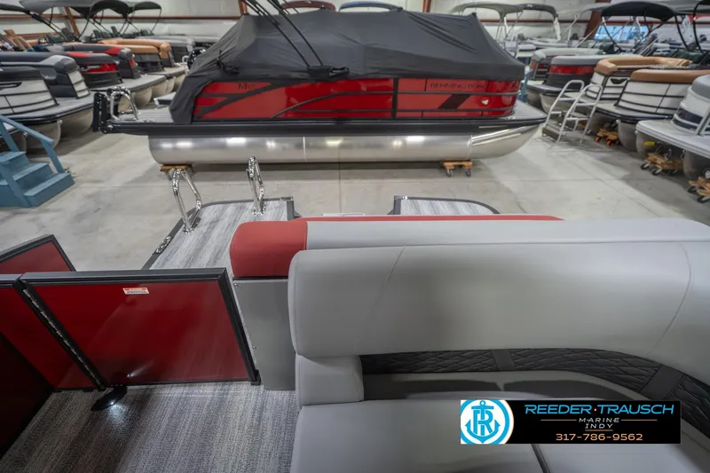 Slide: The Image of 2026 Bennington 22 SLJ pontoon boat interior with red and gray seating in showroom. - 18