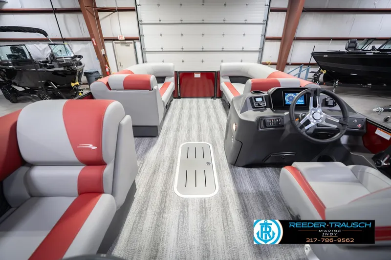 Slide: The Image of 2026 Bennington 22 SLJ pontoon boat interior with red and gray seating, modern dashboard. - 20